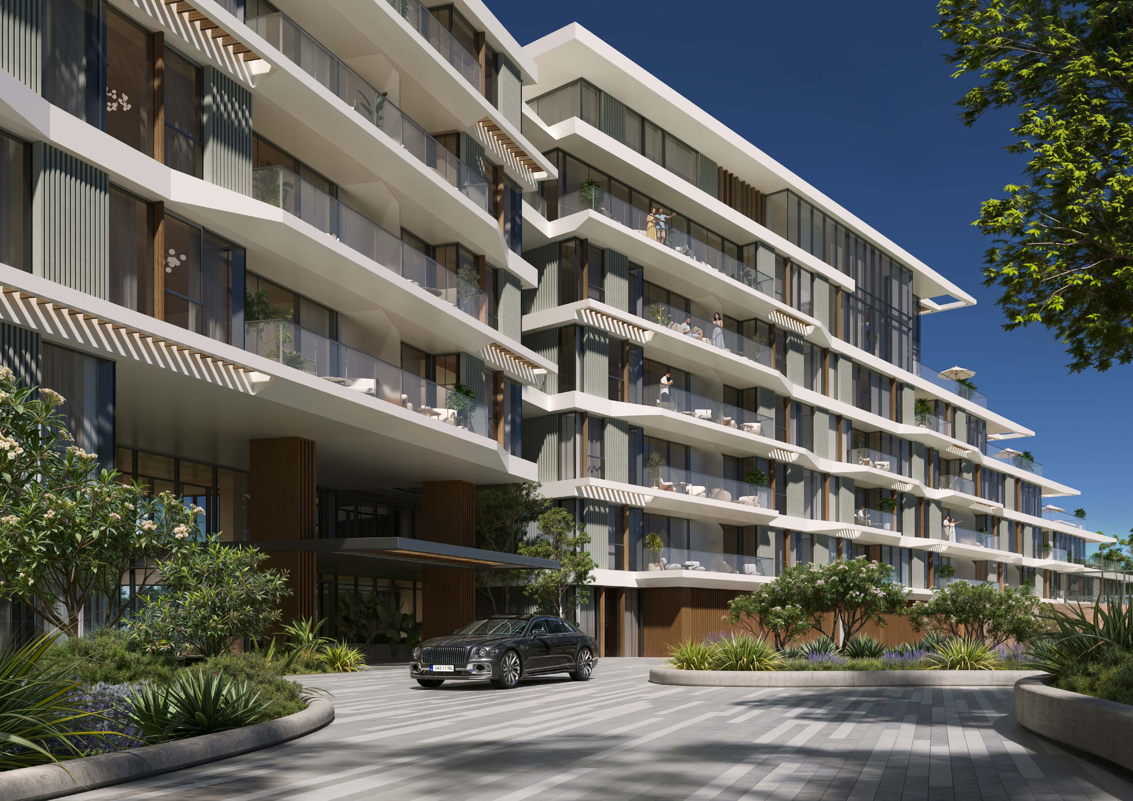 Building facade with layered balconies above a landscaped drop-off