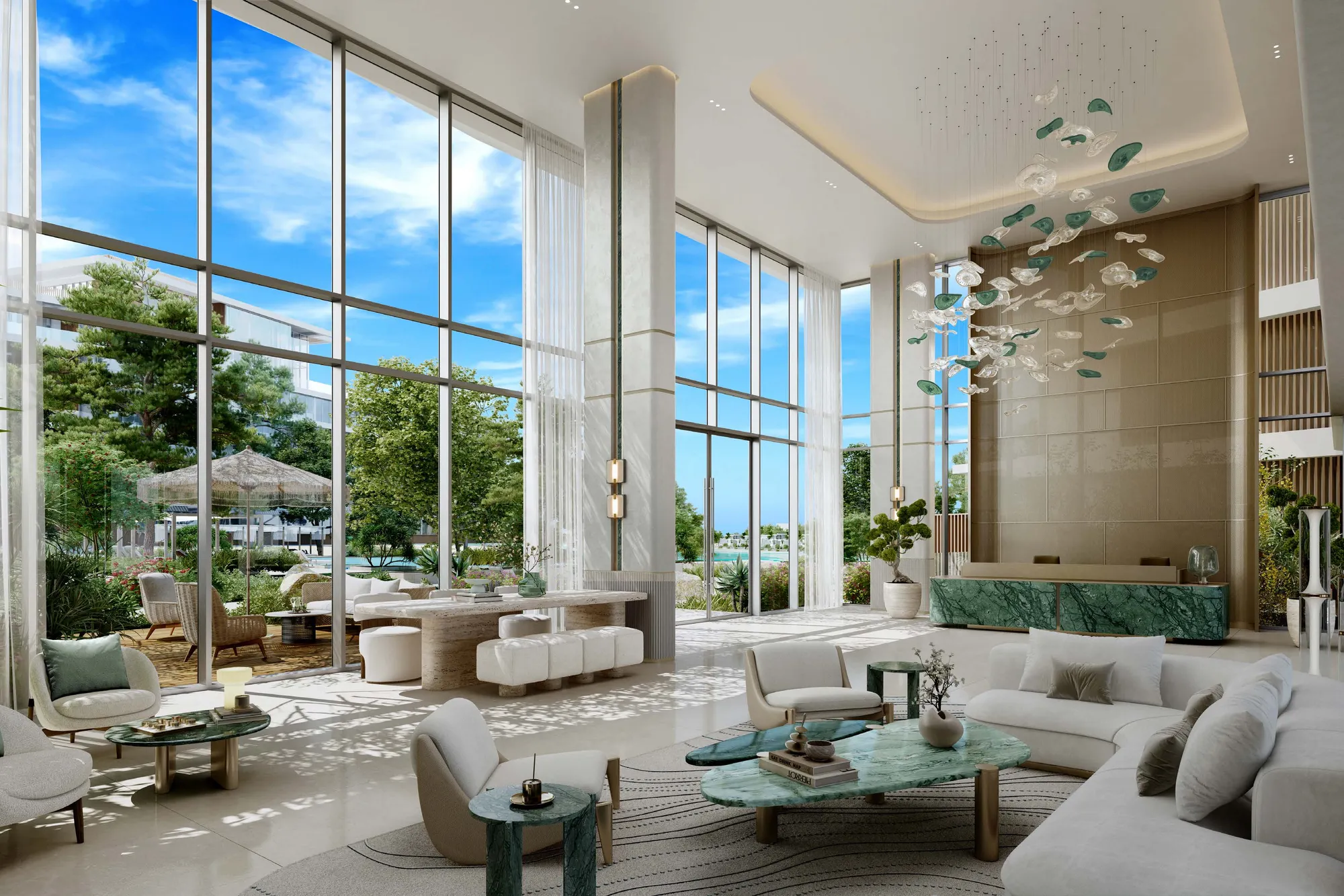 Bright double-height lobby with green marble tables and tall windows onto gardens