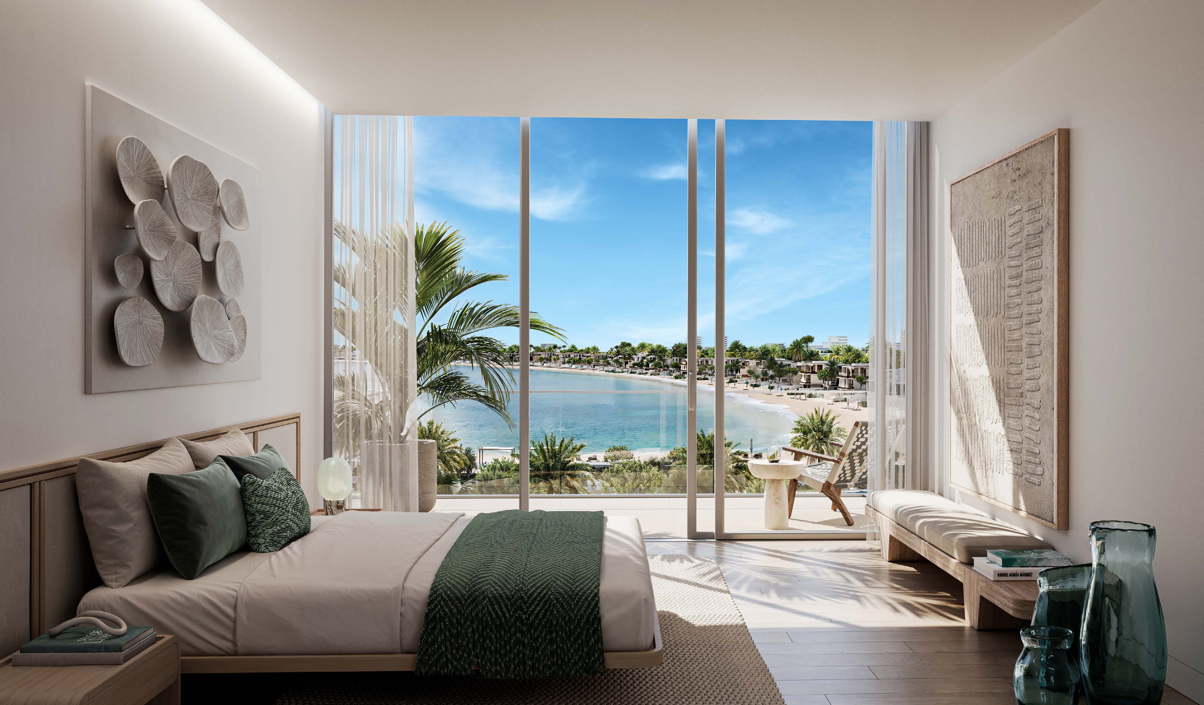 Master bedroom with full-height glass looking over palms to the beach
