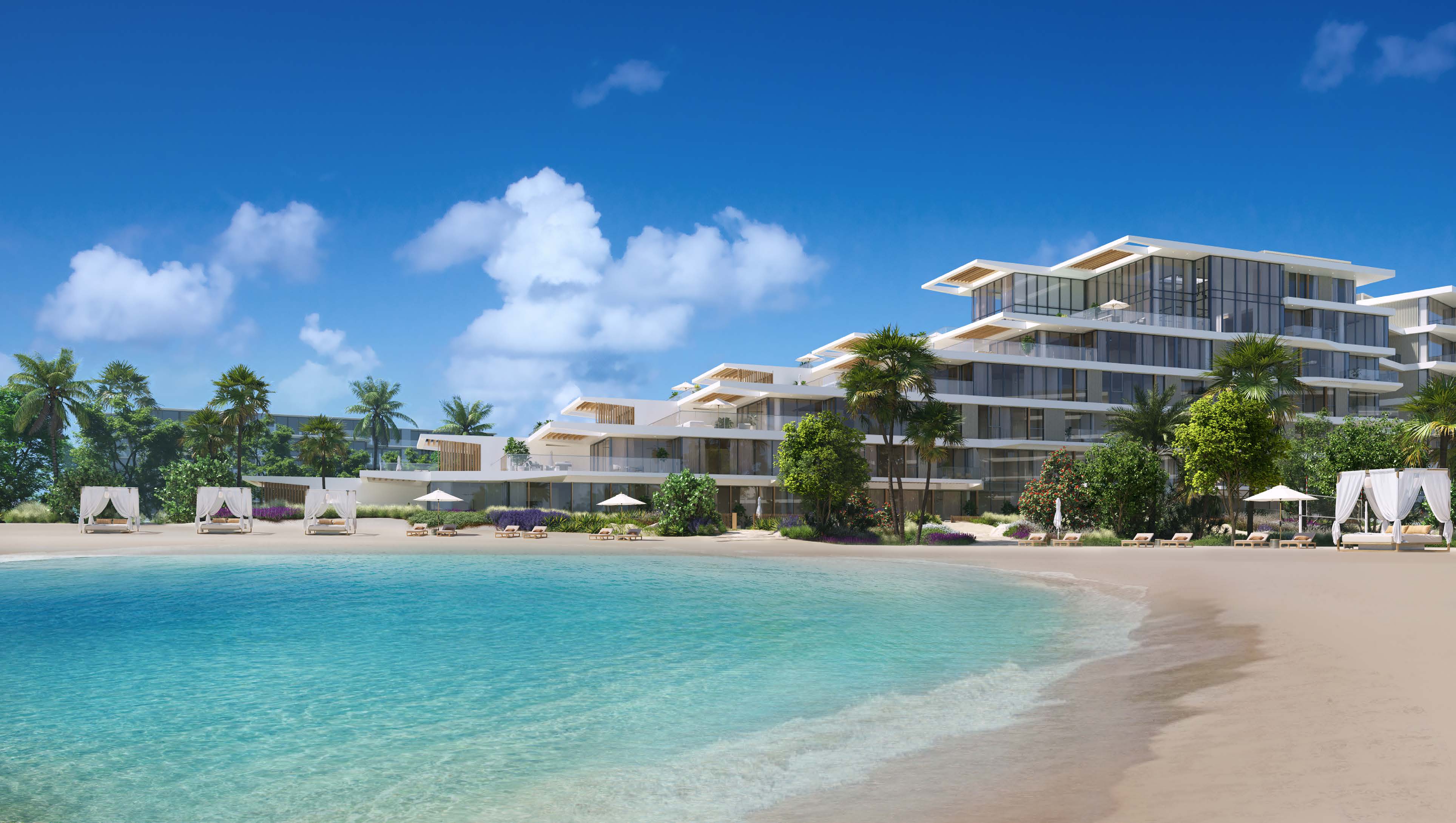 Stepped white building behind palms, cabanas and a curving turquoise beach